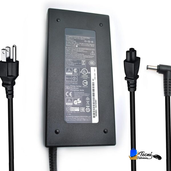 Black rectangular AC power adapter with printed label, showing two-prong plug on the left and a right-angled plug on the right connected by cords.